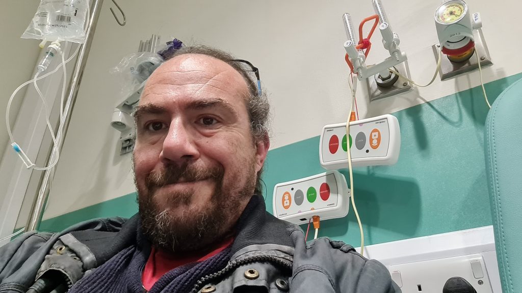 A photo of Dave sat at the hospital